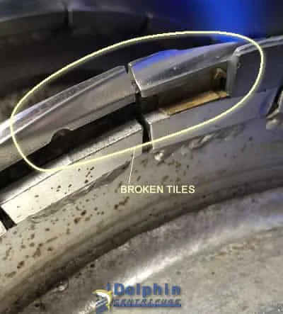 Decanter Auger with Broken and Missing Tiles showing erosion protection damage