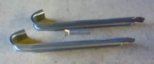 Centrifuge bowl port liners - stamped steel clips protecting sludge ports