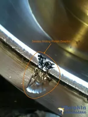 Centrifuge sliding piston lip erosion detail showing wear damage