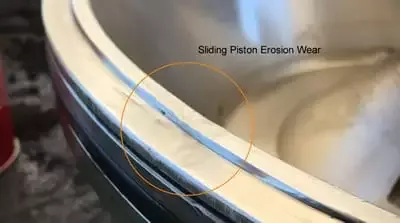 Centrifuge sliding piston lip erosion caused by leaking bowl seal