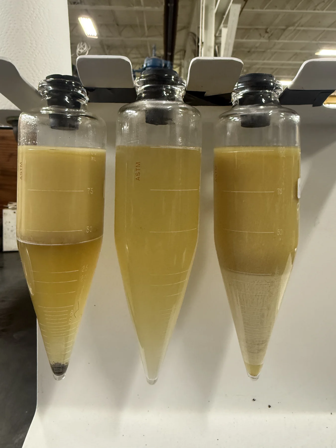 Hydraulic oil, water, and emulsion sample after 3-phase separation testing